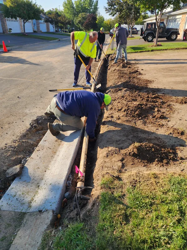 Ristau crew installing concrete curb edging at street