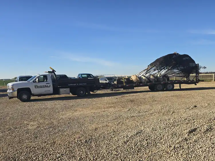 Ristau flatbed trailer hauling large balled and burlapped tree to job site