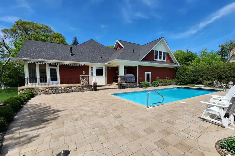 Large paver patio with pool surround at residential outdoor living space