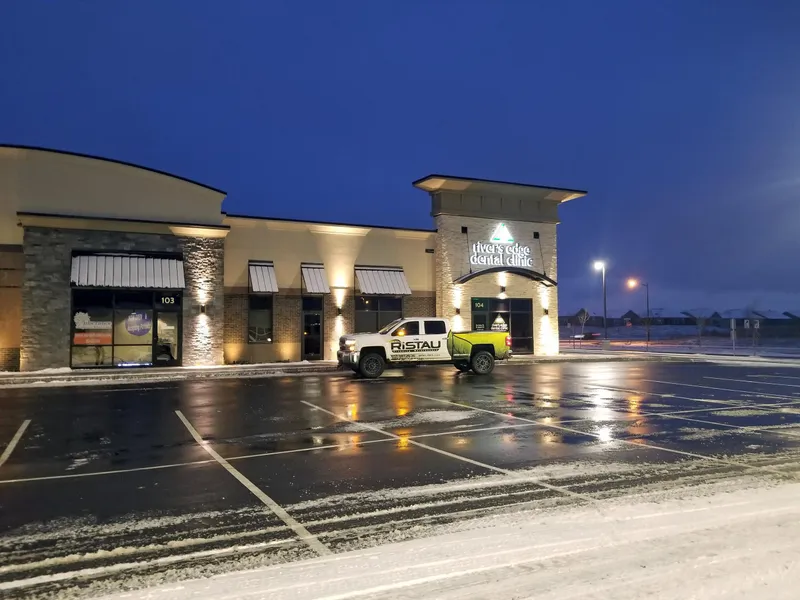Ristau truck servicing a retail strip center at dawn