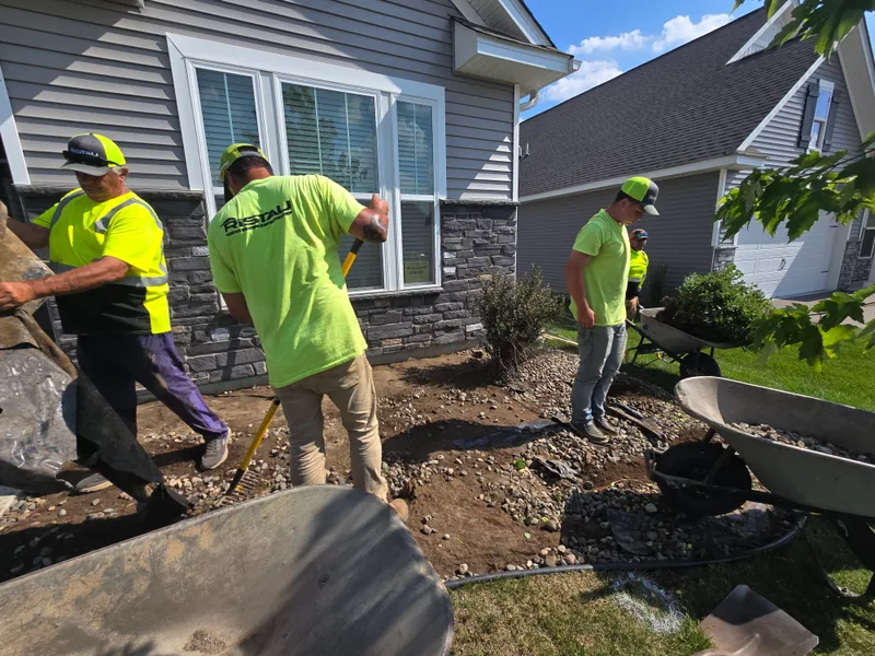 Ristau Property Maintenance crew installing landscape bed at residential home