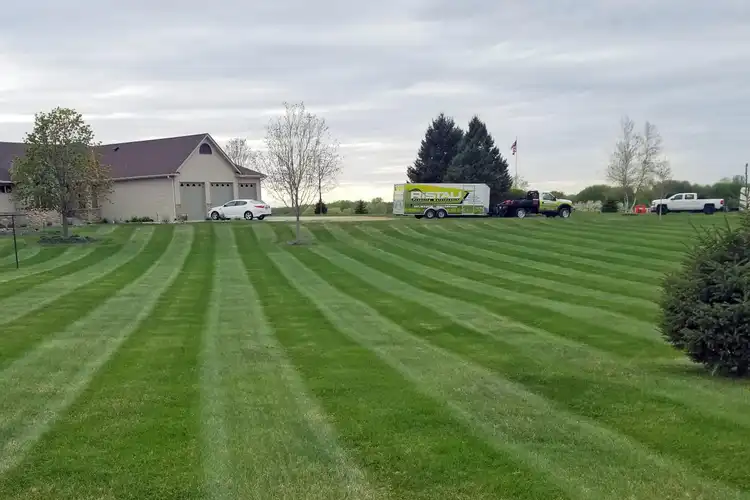 Ristau truck and trailer with mowing stripes on commercial property
