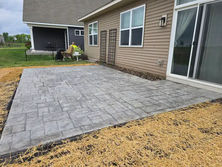Finished stamped concrete patio at backyard of new construction home